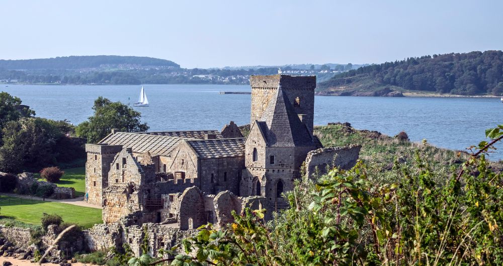 View over Inchcolm Abbey to a sailing boat on the Firth of Forth